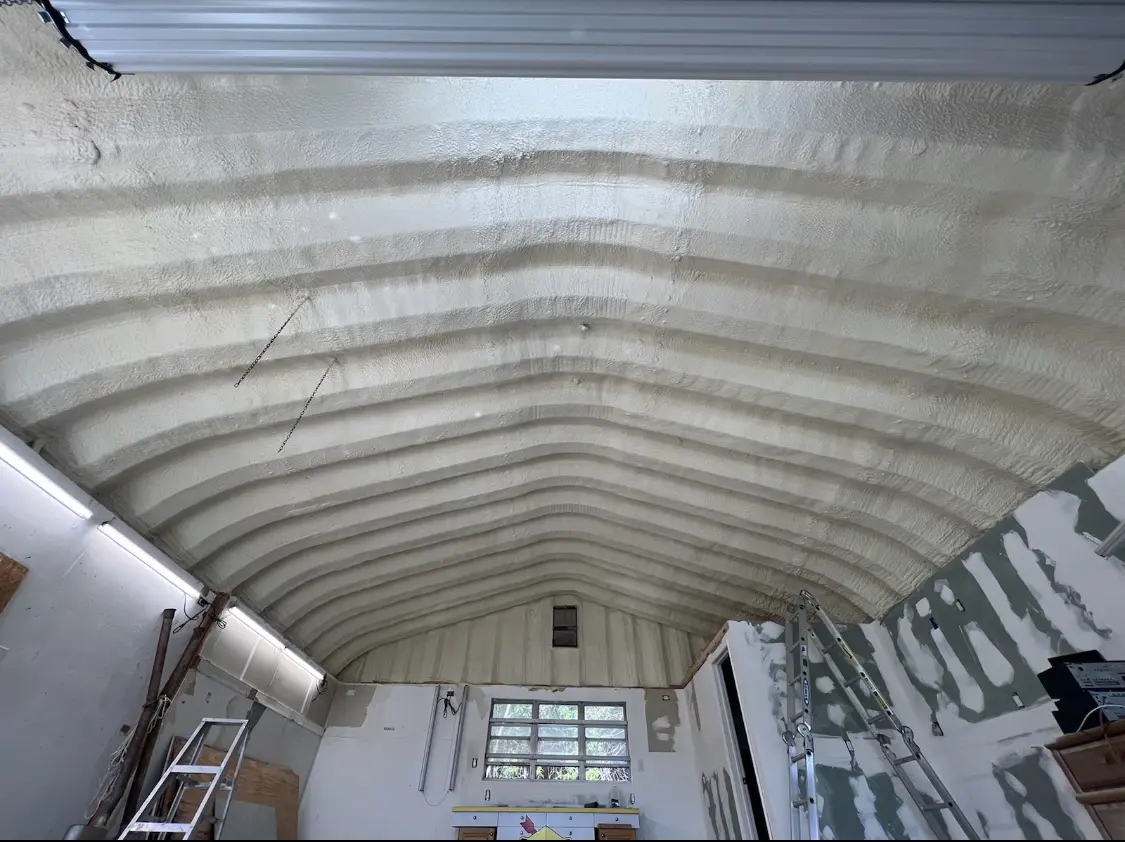 Spray polyurethane foam applied to the underside of a metal roof deck in Geneseo